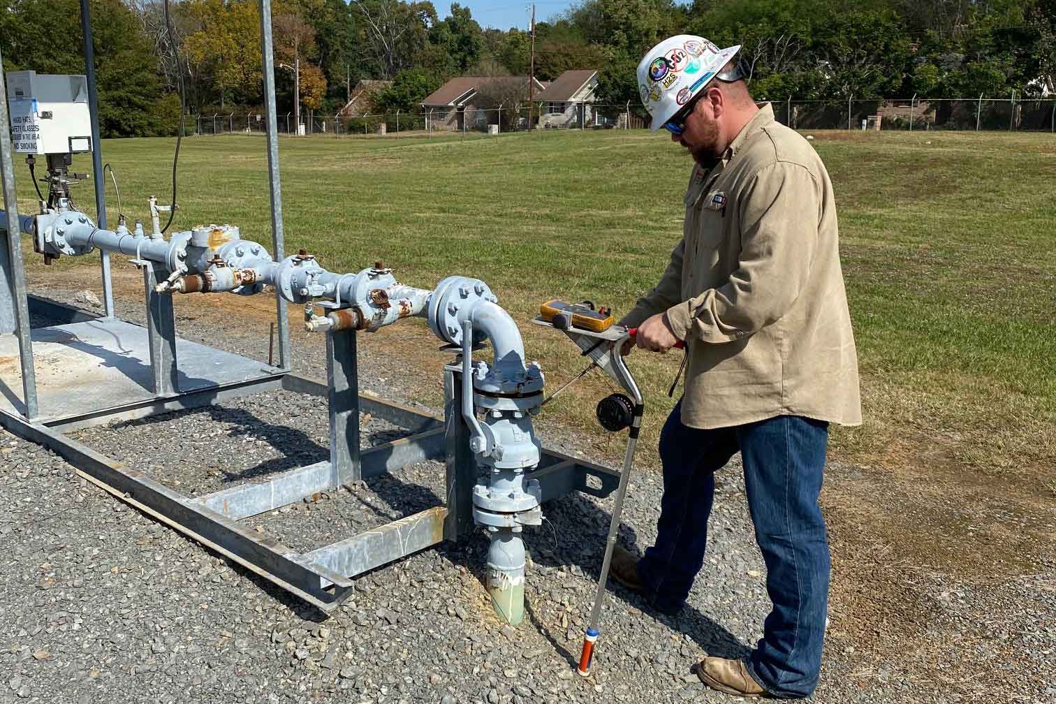 Worker testing corrosion resistence of pipe